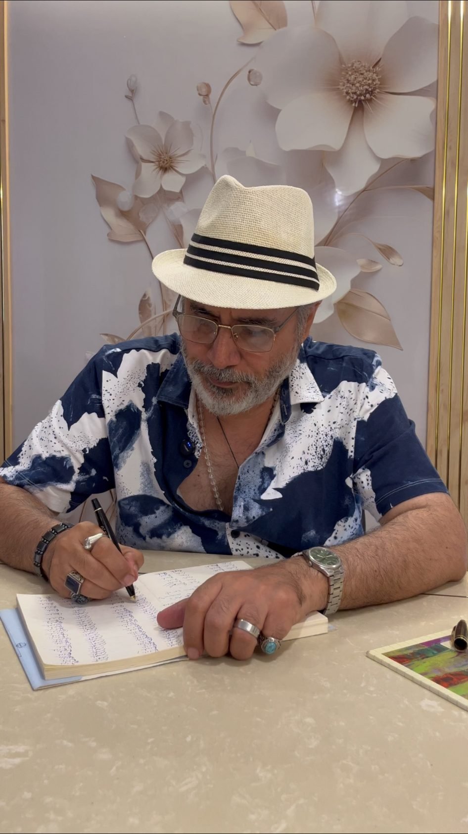 Manu Shandilya Ji writing notes at a table